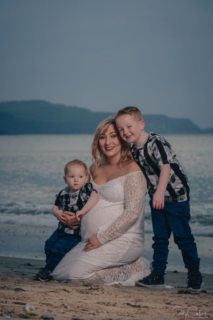A Northern Ireland family poses on the beach.