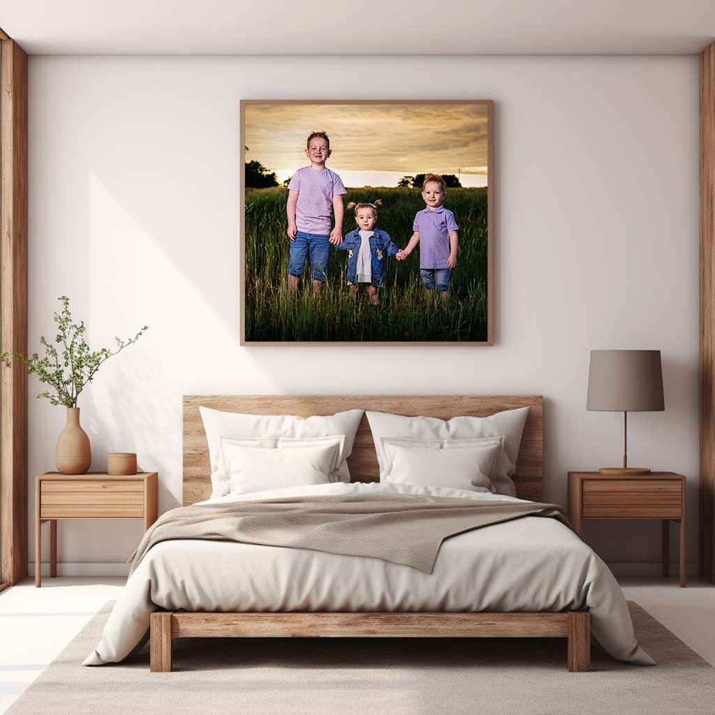 A photo of a family in Northern Ireland standing in front of a bed, captured by a family photographer.