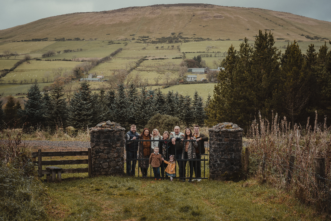 Family Photographer A group of people standing in front of a fence.