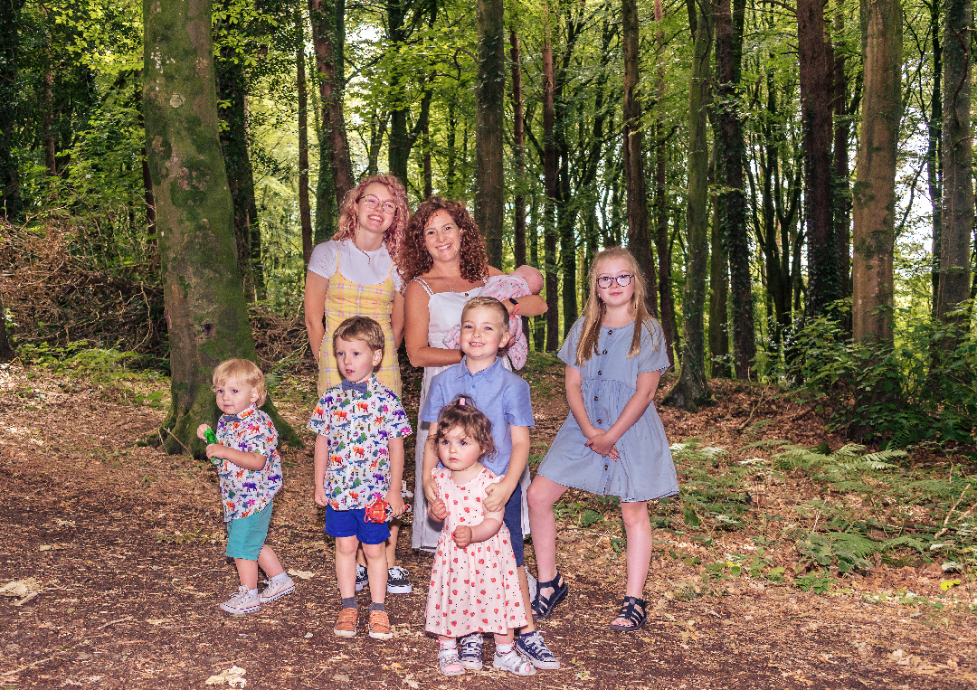 Ballymoney photographer, Family Photographer A family posing for a photo in the woods.