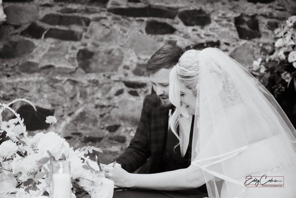 Family Photographer A man and woman signing a marriage contract.